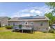 Back exterior view of house showing solar panels, deck, siding, and manicured lawn at 206 Pine Meadow St, Hickory, NC 28601