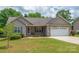 Attractive home with lush landscaping, cozy front porch, and two-car garage at 206 Pine Meadow St, Hickory, NC 28601