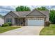 Home featuring a brick-accented two-car garage with a nicely landscaped yard at 206 Pine Meadow St, Hickory, NC 28601