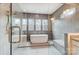 Spa bathroom showcasing freestanding tub, tiled shower, and bronze fixtures for an elegant design at 206 Streamwood Rd # 32, Troutman, NC 28166