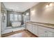 Spa bathroom featuring a luxurious soaking tub, tiled shower, and double vanity with granite countertop at 206 Streamwood Rd # 32, Troutman, NC 28166