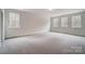 Large bedroom with neutral carpet and three large windows at 206 Streamwood Rd # 32, Troutman, NC 28166