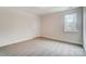 A bright bedroom with neutral carpet, a window and a white door at 206 Streamwood Rd # 32, Troutman, NC 28166