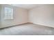 This bedroom features neutral walls, carpet, and a window at 206 Streamwood Rd # 32, Troutman, NC 28166