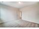 A light and airy bedroom with plush carpeting and an open doorway at 206 Streamwood Rd # 32, Troutman, NC 28166