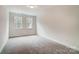 Comfortable carpeted bedroom bathed in natural light from two windows, ready for personalization at 206 Streamwood Rd # 32, Troutman, NC 28166