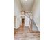 Bright foyer features wood floors, staircase, and views into other rooms, creating an inviting entrance to the home at 206 Streamwood Rd # 32, Troutman, NC 28166