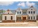 Charming two-story home with stone accents, a covered porch, and a well-manicured lawn at 206 Streamwood Rd # 32, Troutman, NC 28166