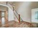Spacious foyer featuring a staircase, hardwood floors, and access to other rooms at 206 Streamwood Rd # 32, Troutman, NC 28166