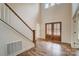Grand foyer with a staircase, wood floors, and double front doors for an inviting entrance at 206 Streamwood Rd # 32, Troutman, NC 28166