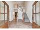 Spacious foyer with wood floors, a staircase, and a view into the living room at 206 Streamwood Rd # 32, Troutman, NC 28166