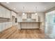 Bright kitchen with white cabinets, stainless appliances, and an island at 206 Streamwood Rd # 32, Troutman, NC 28166