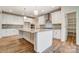 Spacious kitchen with white cabinets, granite counters, and wood flooring at 206 Streamwood Rd # 32, Troutman, NC 28166