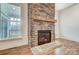 Living room features a stone fireplace, hardwood floors, and large windows for natural light at 206 Streamwood Rd # 32, Troutman, NC 28166