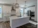 Modern kitchen featuring white cabinets, stainless steel appliances, and a large island with countertop seating at 2068 Fordhill St, Rock Hill, SC 29732