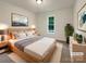 This staged bedroom offers natural light, neutral walls, carpeted floors, and a serene atmosphere for relaxation at 211 Sherwood Cir, Rock Hill, SC 29730