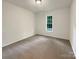 This carpeted bedroom is a blank canvas awaiting personalization, with neutral walls and a window bringing the outdoors in at 211 Sherwood Cir, Rock Hill, SC 29730