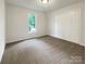 Bright bedroom with neutral carpet, a double door closet, and a window overlooking the neighborhood at 211 Sherwood Cir, Rock Hill, SC 29730