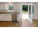 Well lit kitchen with stainless steel appliances, warm tile flooring, and access to the backyard at 211 Sherwood Cir, Rock Hill, SC 29730