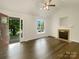 Bright living room featuring a fireplace, hardwood floors, a ceiling fan, and view of the manicured yard at 211 Sherwood Cir, Rock Hill, SC 29730