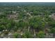 A wide aerial shot showcases the community with mature trees and nearby amenities at 2213 Milton Rd, Charlotte, NC 28215