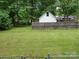 Spacious backyard with mature trees and a privacy fence, perfect for outdoor activities at 2213 Milton Rd, Charlotte, NC 28215