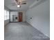 Finished basement with a ceiling fan, storage cabinets, and a door to the exterior at 2213 Milton Rd, Charlotte, NC 28215