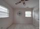 Clean, bright bedroom with a ceiling fan, two windows, and a compass wall decoration at 2213 Milton Rd, Charlotte, NC 28215