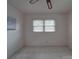 Minimalist bedroom featuring white walls, carpet, and a ceiling fan at 2213 Milton Rd, Charlotte, NC 28215