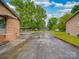 Spacious driveway with fenced yard, brickwork, and detached garage at 2213 Milton Rd, Charlotte, NC 28215