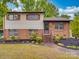 Inviting two-story home with brick and siding, featuring well-maintained landscaping and a cozy entrance at 2213 Milton Rd, Charlotte, NC 28215