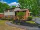 Charming two-story home with brick and siding, complemented by lush landscaping and a welcoming walkway at 2213 Milton Rd, Charlotte, NC 28215