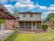 Rear exterior view of home with large screened-in porch and carport at 2213 Milton Rd, Charlotte, NC 28215