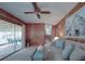 Open living room with sliding glass doors that lead to a screened-in porch and backyard access at 2213 Milton Rd, Charlotte, NC 28215