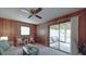 Charming living room with wood paneling, sliding glass doors, and comfortable seating at 2213 Milton Rd, Charlotte, NC 28215