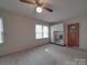 An empty room has two double-hung windows that provide natural light and built-in cabinets for storage at 2213 Milton Rd, Charlotte, NC 28215