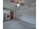 Empty room with carpet, white walls, and a wooden door with a window pane at 2213 Milton Rd, Charlotte, NC 28215