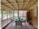 Inviting sunroom with screened windows, dining set and view of backyard at 2213 Milton Rd, Charlotte, NC 28215