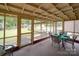 Inviting sunroom with screened windows, dining set and view of backyard at 2213 Milton Rd, Charlotte, NC 28215