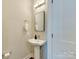 Clean half bathroom with a pedestal sink and modern fixtures at 2401 Euclid Ave # 207, Charlotte, NC 28203