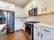Bright, modern kitchen with stainless steel appliances and stylish white cabinets at 2401 Euclid Ave # 207, Charlotte, NC 28203