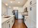 Modern kitchen featuring stainless steel appliances, white cabinetry, and hardwood floors at 2401 Euclid Ave # 207, Charlotte, NC 28203