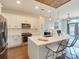 Bright open kitchen with quartz countertops, stainless appliances, and island seating at 2401 Euclid Ave # 207, Charlotte, NC 28203