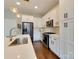 Contemporary kitchen featuring white cabinets, stainless steel appliances, and a stylish island at 2401 Euclid Ave # 207, Charlotte, NC 28203