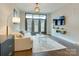 Bright living room featuring a couch, television, and large windows to the balcony at 2401 Euclid Ave # 207, Charlotte, NC 28203