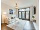 Bright living room featuring a couch, television, and large windows to the balcony at 2401 Euclid Ave # 207, Charlotte, NC 28203