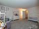 Bedroom featuring a crib, changing table, and gray carpet at 2437 Woodleigh Dr, Gastonia, NC 28056