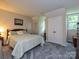 Bedroom with light green walls, carpet, a bed, and a double door closet at 2437 Woodleigh Dr, Gastonia, NC 28056