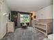 Neutral Bedroom offers a calming atmosphere with natural light, complemented by soft gray carpet and charming decor at 2437 Woodleigh Dr, Gastonia, NC 28056