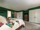 Cozy bedroom features a comfortable quilt, lots of closet space and carpet floors at 2437 Woodleigh Dr, Gastonia, NC 28056
